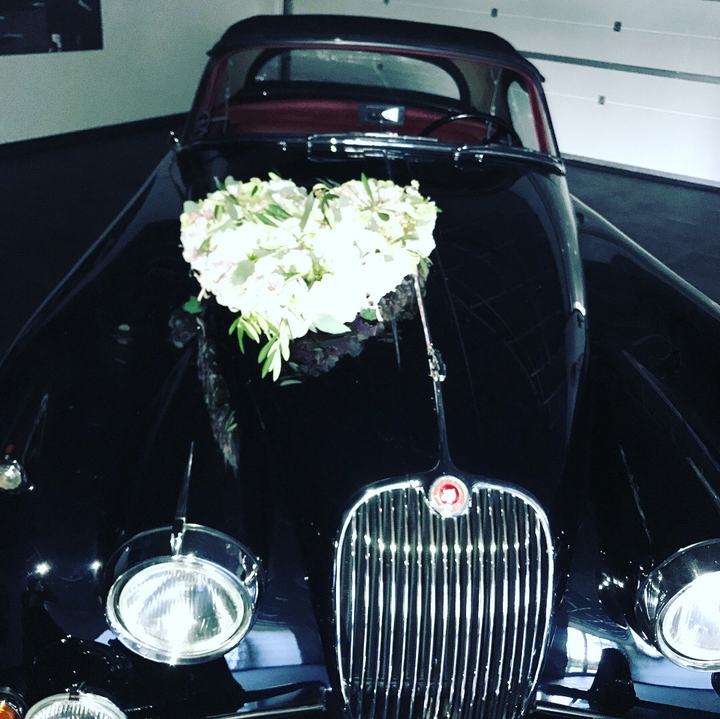 Hochzeitsauto mit weißem Herzgesteck